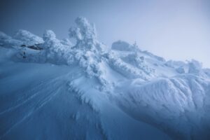 A snow covered mountain with a sky background